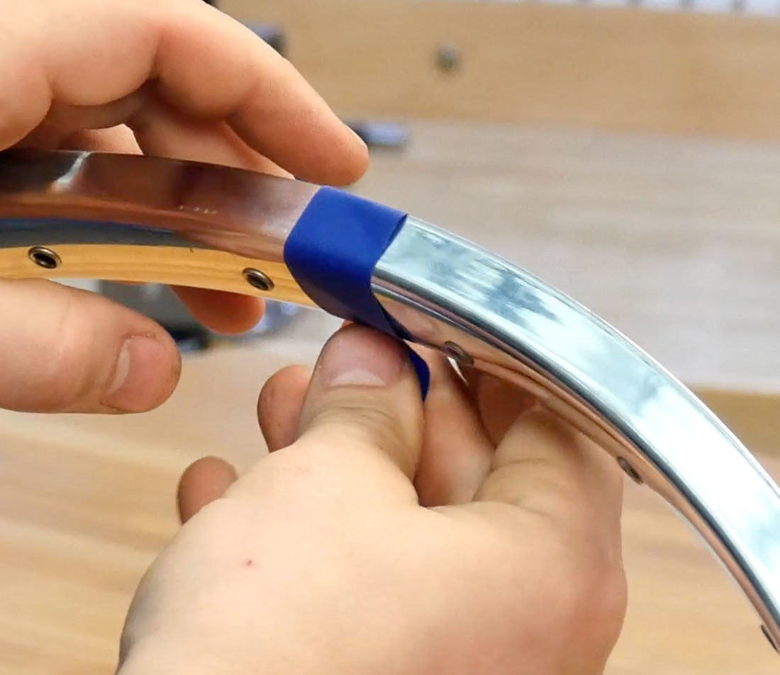 Blue masking tape being applied to chosen section of a rim as a reference mark