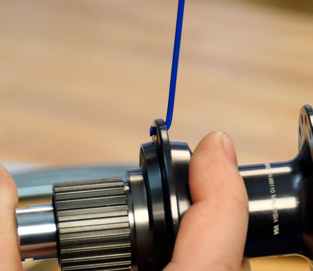 A single spoke installed on the drive side of a hub