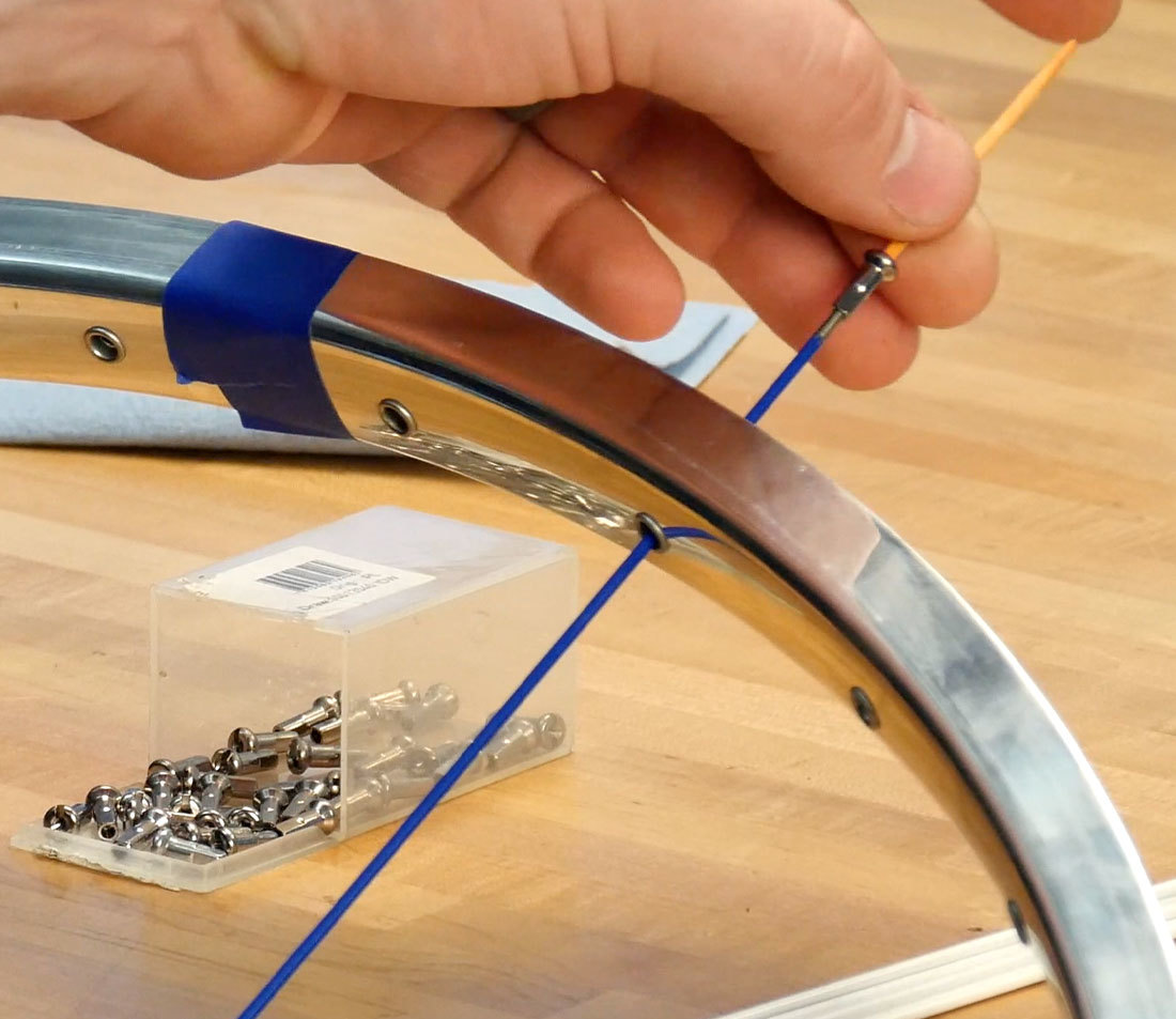 Installing a spoke nipple onto a spoke