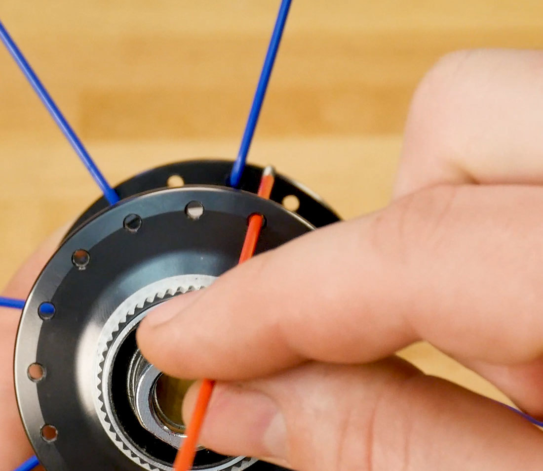View of hub from one side with one spoke inserted to show slight offset from spokes on opposite side