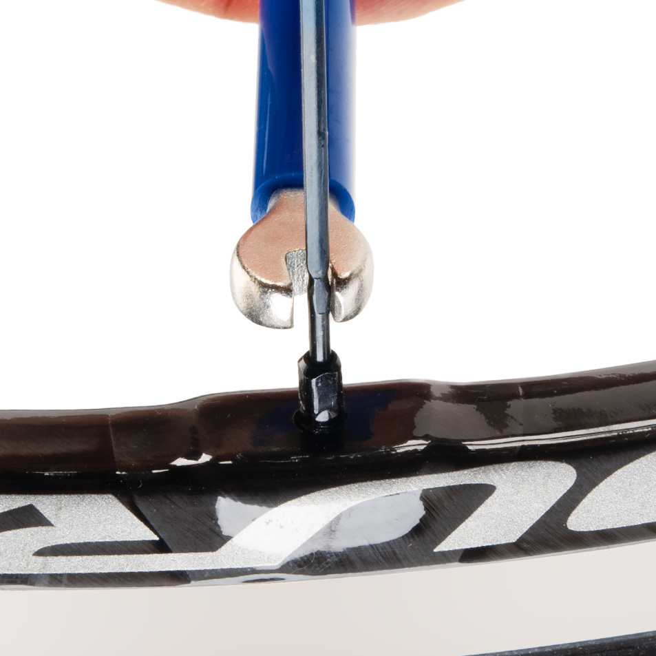 SW-14.5 double-ended spoke wrench being fitted to square Shimano® spoke nipple on wheel