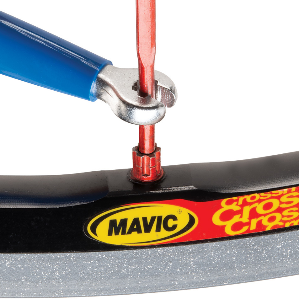 SW-13 double-ended spoke wrench being fitted to Mavic® six-splined spoke nipple on wheel